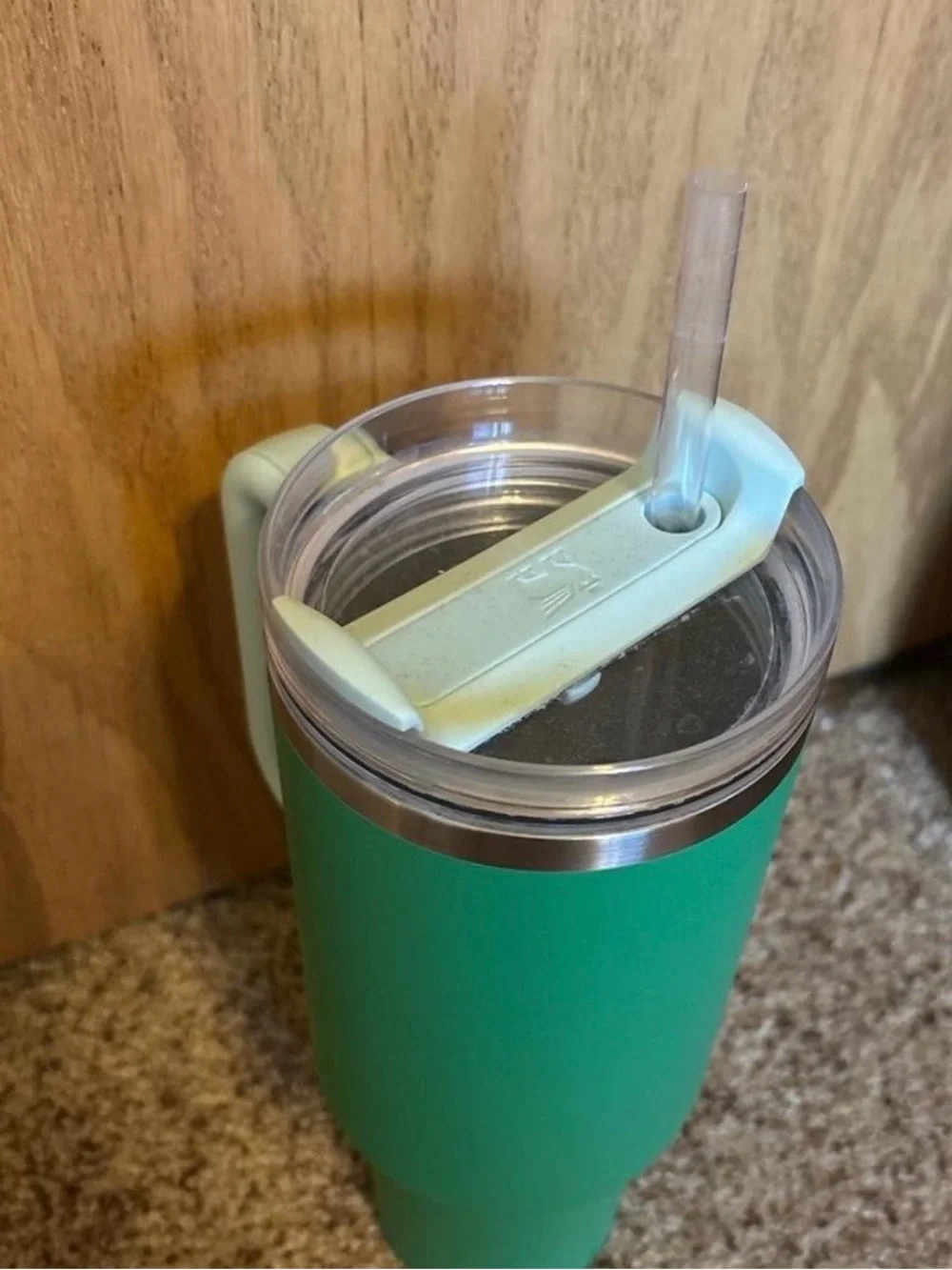 Stanley Green Tumbler with Light Blue Handle and Lid Accent